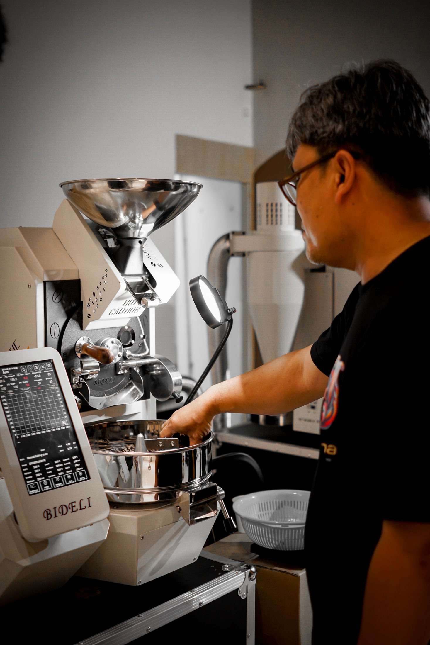 A competitor working a Bideli roaster at KPIC 2026 in Yangon